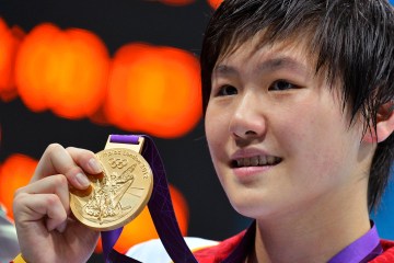 China's Ye Shiwen poses with her gold medal after winning the women's 200m individual medley final during the London 2012 Olympic Games at the Aquatics Center on July 31, 2012.