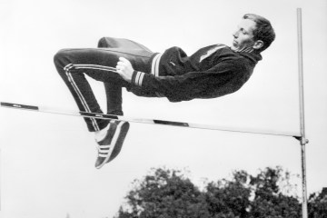 American high jump champion Dick Fosbury clears the bar during practice