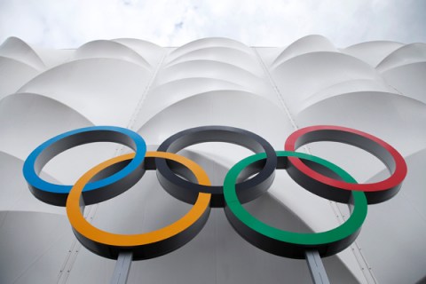 The Olympic rings are displayed outside the basketball arena in the Olympic Park before the start of  the 2012 Summer Olympics, Sunday, July 15, 2012, in London.