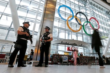Airport police keep patrol at an arrival terminal at Heathrow Airport as London prepares for the 2012 Summer Olympics, July 18, 2012.
