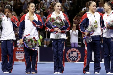 From left: Gabby Douglas, Aly Raisman, McKayla Maroney, Jordyn Wieber and Sarah Finnegan react while standing on the podium after being announced as members of the U.S. women's Olympic gymnastics team after the final round of the women's Olympic gymnastics trials, Sunday, July 1, 2012, in San Jose, Calif.