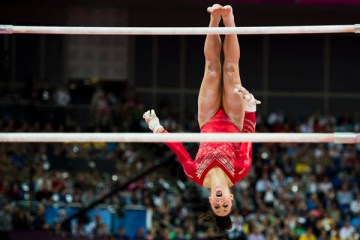 Jordyn Wieber of the United States dismounts from the uneven bars during women's team gymnastics finals at North Greenwich Arena during the 2012 Summer Olympic Games in London, July 31, 2012.