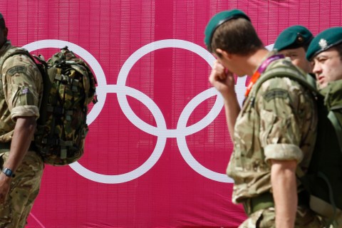 Marines pass the Olympic rings outside the London 2012 Olympic Park at Stratford in London