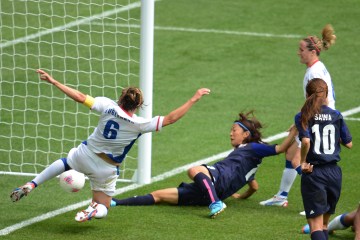 Japan's forward Yuki Ogimi scores a goal in front of France's Sandrine Soubeyrand during the Olympic women's soccer semifinal at Wembley stadium in London on August 6, 2012