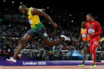 Jamaica's Usain Bolt crosses the finish line to win gold in the men's 100-meter final during the athletics in the Olympic Stadium at the 2012 Summer Olympics, London, Aug. 5, 2012..