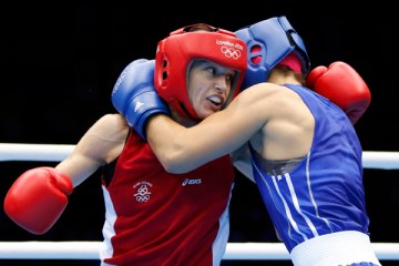 image: Ireland's Katie Taylor, left, fights Russia's Sofya Ochigava during their Women's Light (60kg) gold medal boxing match at the London Olympic Games, Aug. 9, 2012.