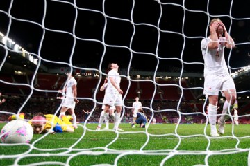 Canada's goalkeeper Erin McLeod, left, looks at the ball shot by USA's Alex Morgan to win the women's semi final soccer match at the London 2012 Olympic Games at Old Trafford in Manchester, Aug. 6, 2012.