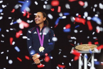 Image: British athlete Jessica Ennis stands on stage with her Olympic gold medal as she arrives for a homecoming party at the Sheffield Town Hall in Sheffield, Aug. 17, 2012.